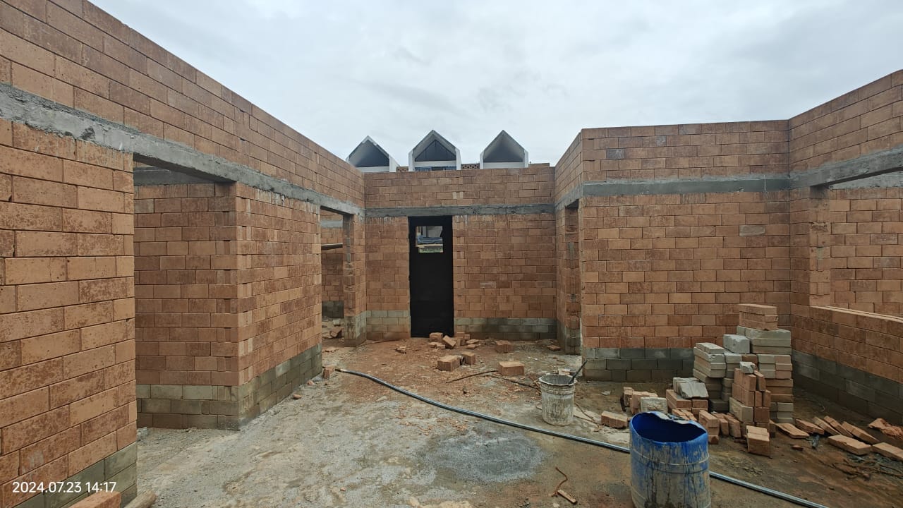 Building under construction using reddish-brown Tetris interlocking bricks